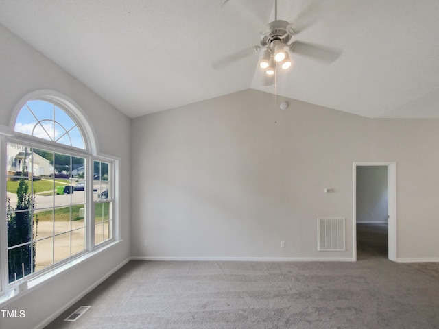 spare room with lofted ceiling, light colored carpet, and ceiling fan