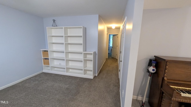 interior space with baseboards and carpet