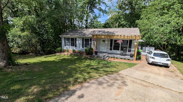 bungalow-style home featuring a porch, roof with shingles, concrete driveway, and a front yard