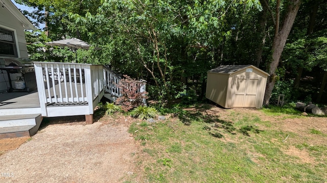 view of yard with a storage shed, a wooden deck, and an outdoor structure
