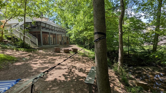 view of yard with stairs and a deck