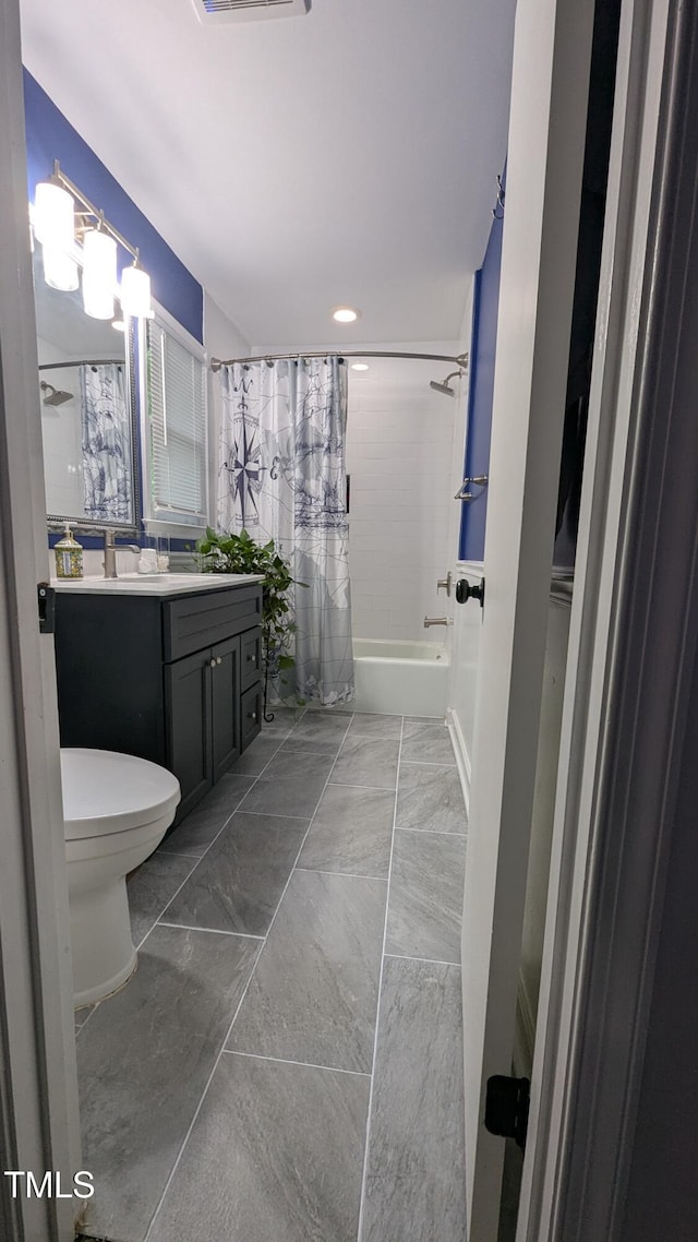 bathroom with vanity, shower / bath combo with shower curtain, marble finish floor, visible vents, and toilet