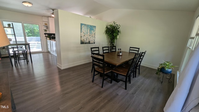 dining space with baseboards, lofted ceiling, and dark wood-type flooring