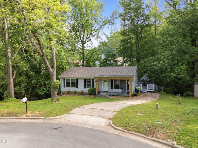 6125 Bellow St, Raleigh, NC 27609 - view of front of home with covered porch, concrete driveway, a front lawn, and roof with shingles