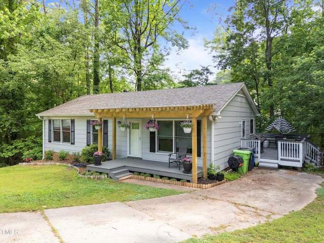 6125 Bellow St, Raleigh, NC 27609 - ranch-style house with a porch, a front yard, and a shingled roof