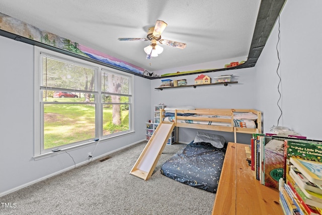 6125 Bellow St, Raleigh, NC 27609 - bedroom with carpet floors, multiple windows, baseboards, a textured ceiling, and ceiling fan