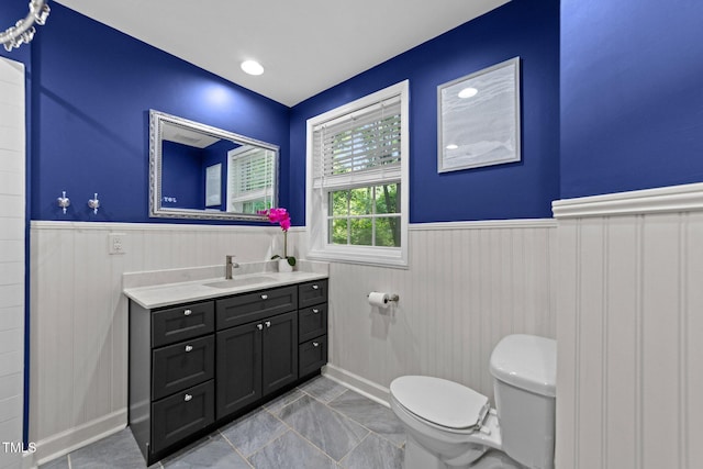 6125 Bellow St, Raleigh, NC 27609 - bathroom featuring wainscoting, toilet, and vanity
