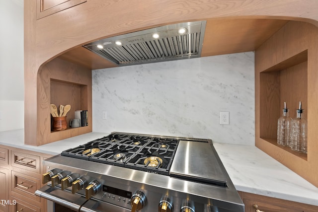 kitchen with decorative backsplash, stainless steel range, and exhaust hood