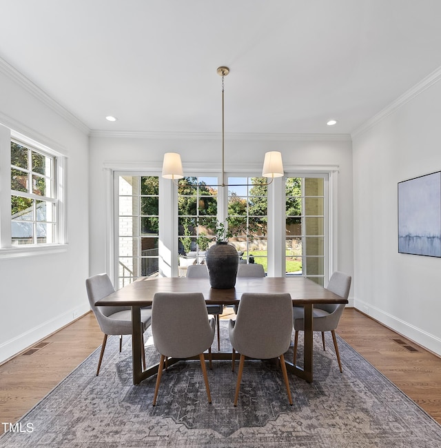 dining room featuring dark hardwood / wood-style floors and ornamental molding