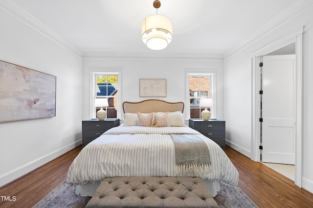 bedroom with dark hardwood / wood-style floors and crown molding