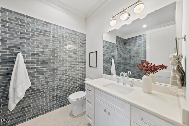 bathroom featuring toilet, tile patterned flooring, vanity, and ornamental molding