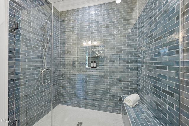 bathroom with crown molding and an enclosed shower