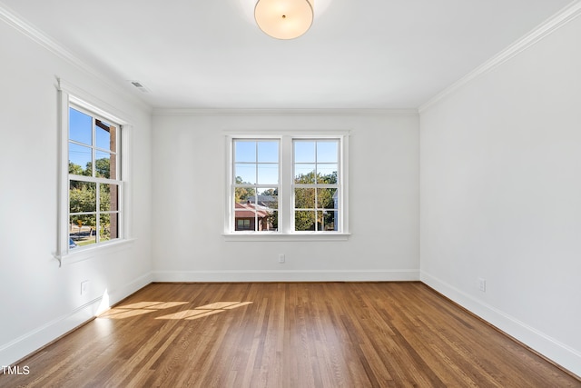 spare room with wood-type flooring and ornamental molding