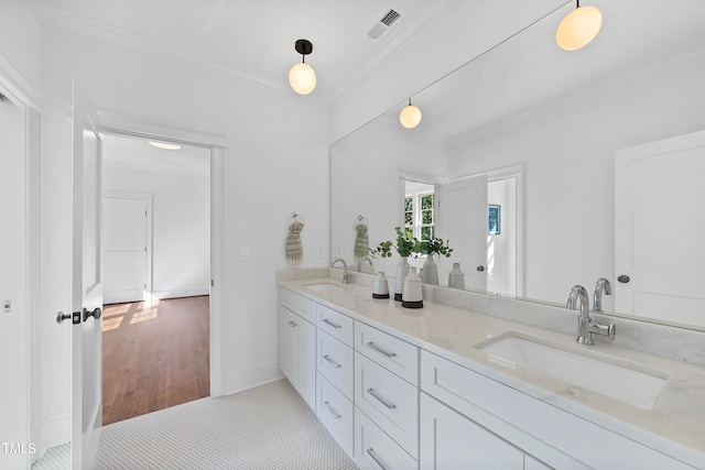 bathroom featuring tile patterned flooring, vanity, and ornamental molding