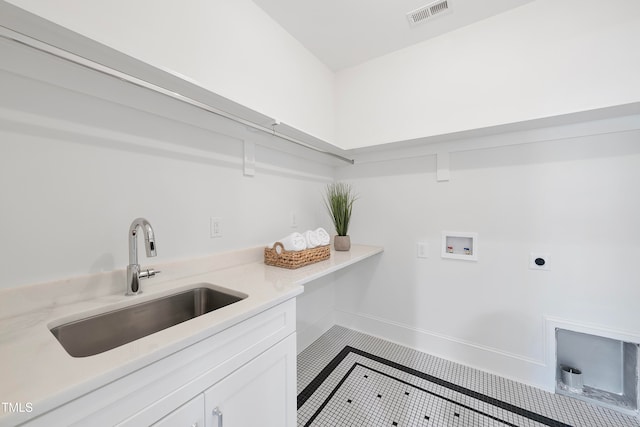 clothes washing area with cabinets, sink, tile patterned flooring, washer hookup, and hookup for an electric dryer