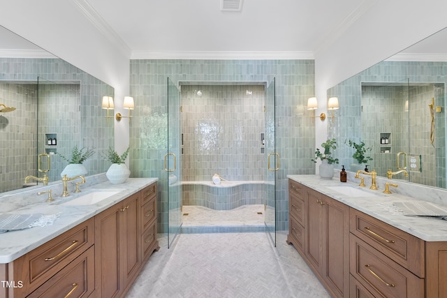 bathroom featuring tile patterned flooring, crown molding, an enclosed shower, vanity, and tile walls