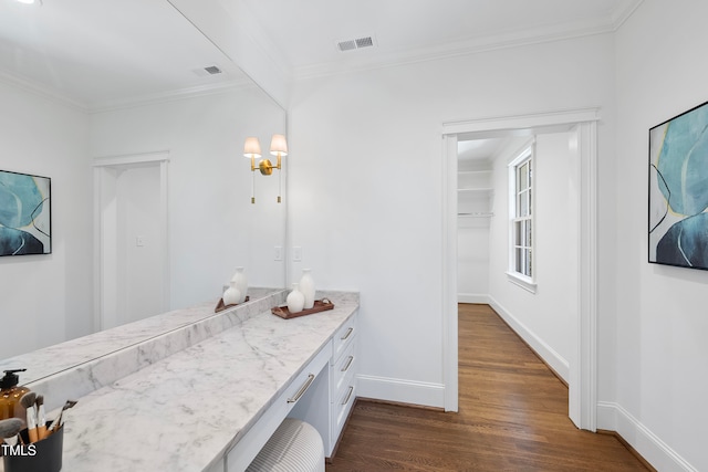 bathroom with vanity, hardwood / wood-style flooring, and ornamental molding