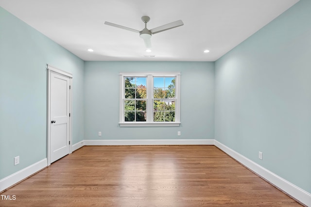 spare room with hardwood / wood-style floors and ceiling fan