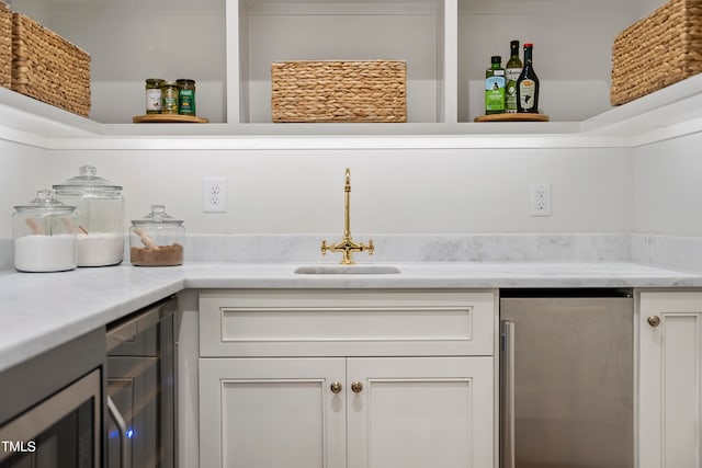 pantry featuring beverage cooler and sink