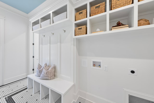 mudroom with tile patterned floors and crown molding