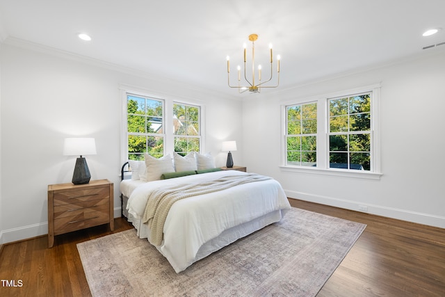 bedroom featuring dark hardwood / wood-style floors, crown molding, and multiple windows