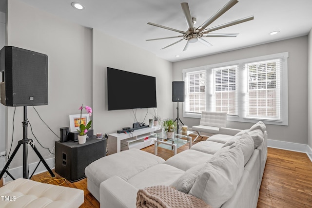 living room featuring ceiling fan and wood-type flooring