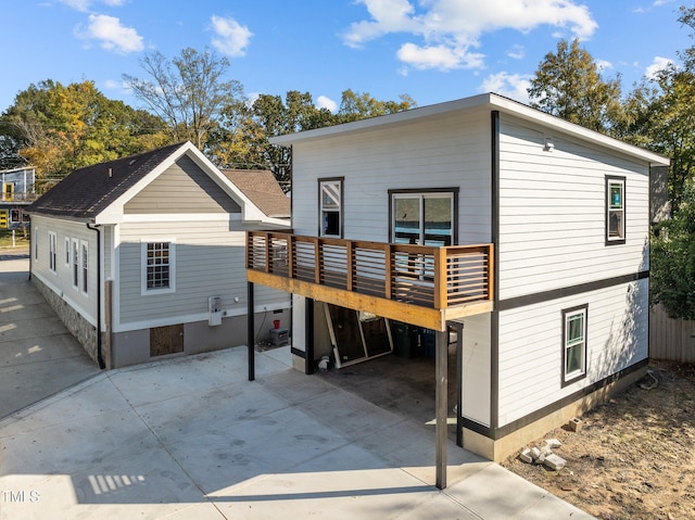 rear view of house with a wooden deck