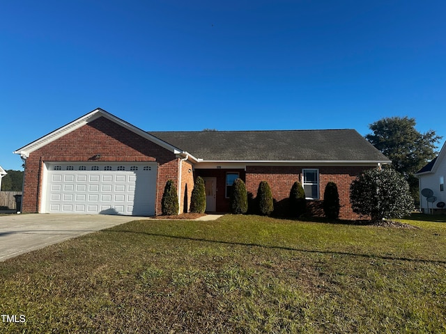 ranch-style house featuring a front lawn and a garage