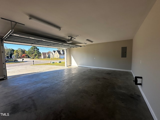 garage featuring electric panel and a garage door opener