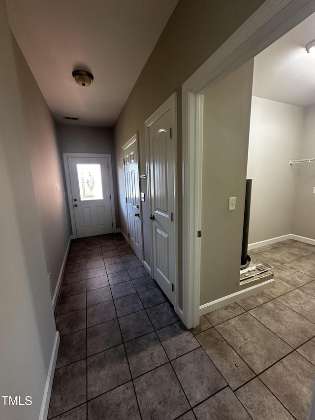 doorway featuring tile patterned flooring