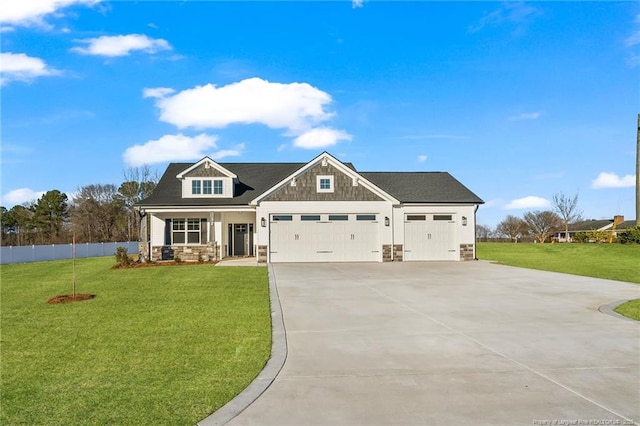 craftsman-style house featuring stone siding, a front yard, an attached garage, and driveway