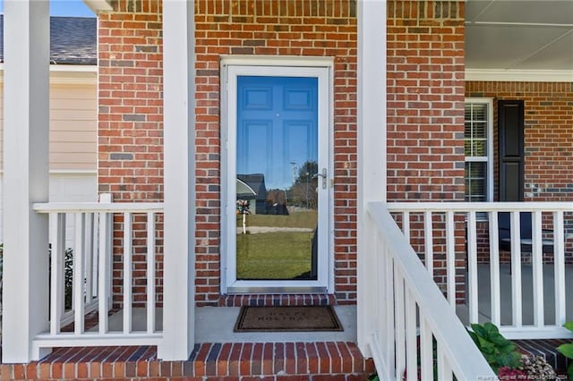 entrance to property featuring a porch