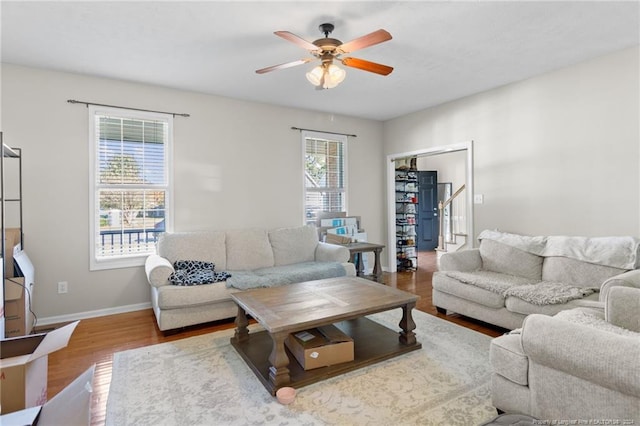 living room featuring hardwood / wood-style flooring and ceiling fan