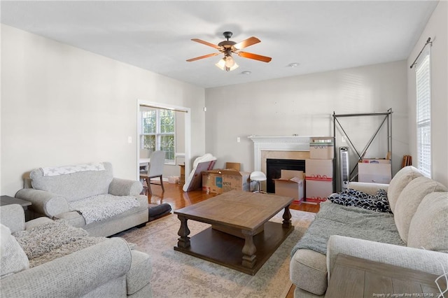 living room featuring hardwood / wood-style floors and ceiling fan