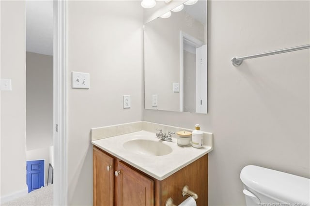 bathroom featuring vanity and toilet