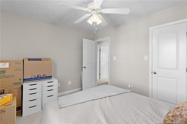 bedroom featuring light carpet and ceiling fan