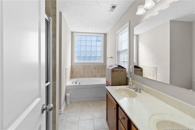 bathroom featuring vanity, a textured ceiling, tile patterned floors, and independent shower and bath