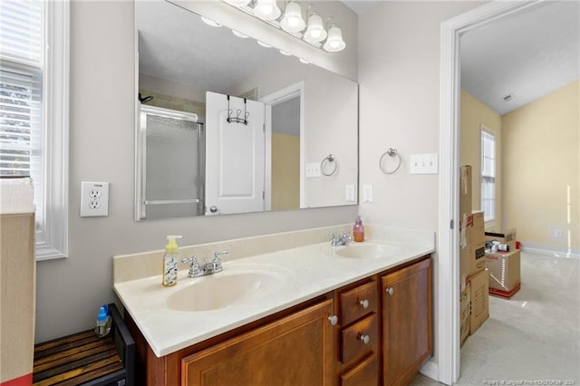 bathroom featuring vanity, vaulted ceiling, a healthy amount of sunlight, and an enclosed shower