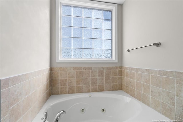 bathroom featuring a bathtub and plenty of natural light