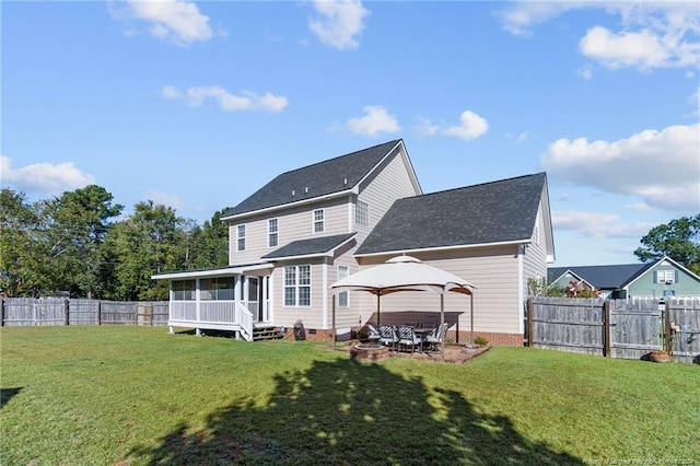 rear view of house with a patio, a gazebo, a sunroom, and a lawn