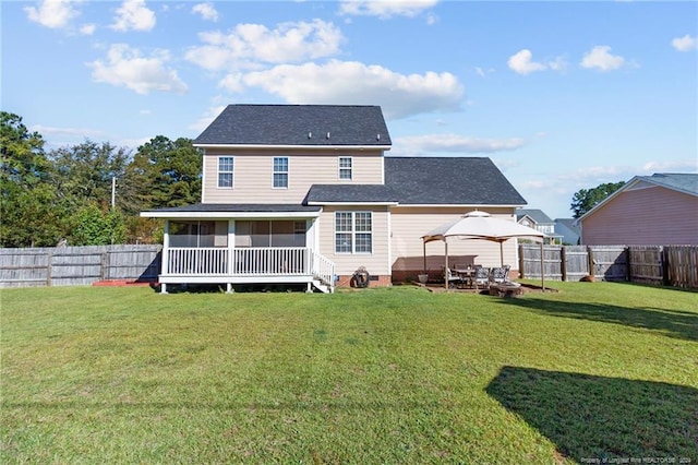 back of house featuring a yard