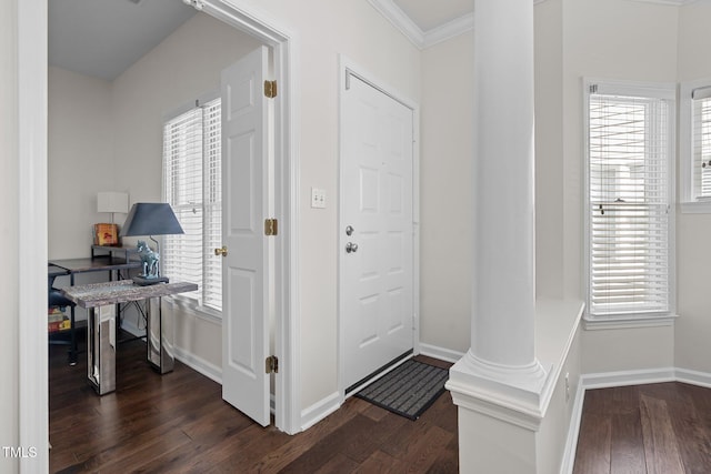 entrance foyer with ornamental molding, dark hardwood / wood-style flooring, and decorative columns