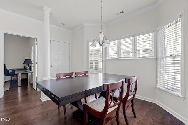 dining space with ornate columns, ornamental molding, a healthy amount of sunlight, and dark hardwood / wood-style flooring