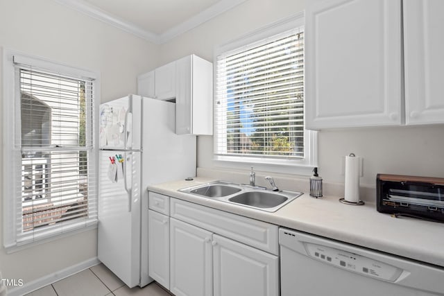 kitchen featuring light tile patterned flooring, sink, white cabinets, crown molding, and white appliances