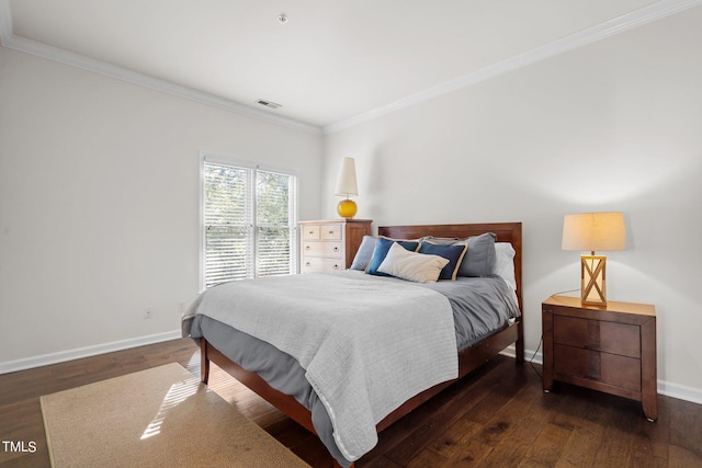 bedroom with ornamental molding and dark hardwood / wood-style floors