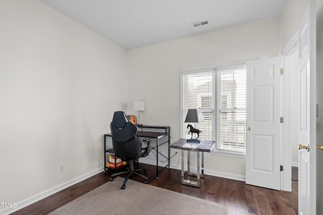 office area featuring plenty of natural light and dark hardwood / wood-style flooring