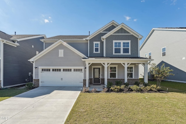 craftsman-style house featuring a front yard, a garage, and covered porch