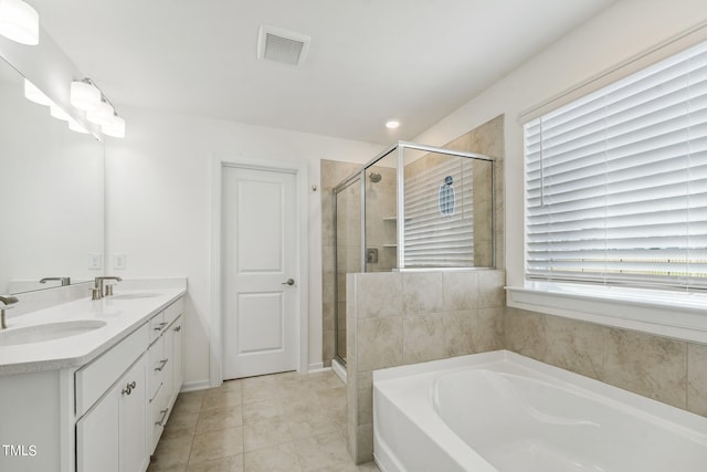 bathroom with vanity and separate shower and tub