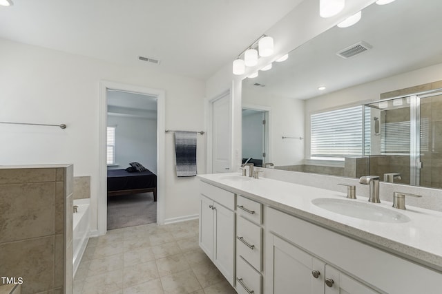 bathroom featuring vanity, tile patterned floors, and shower with separate bathtub