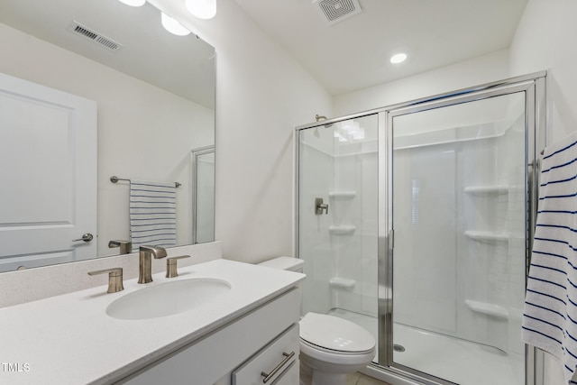 bathroom with toilet, a shower with shower door, and vanity